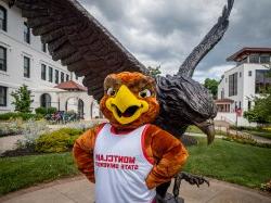 Mascot, Rocky, in front of Red Hawk statue