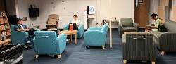 students sitting in library lounge