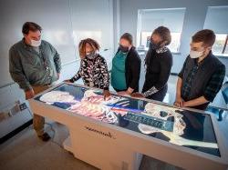 School of Nursing faculty demonstrating the Anatomage Table 8 in the Simulation Center.